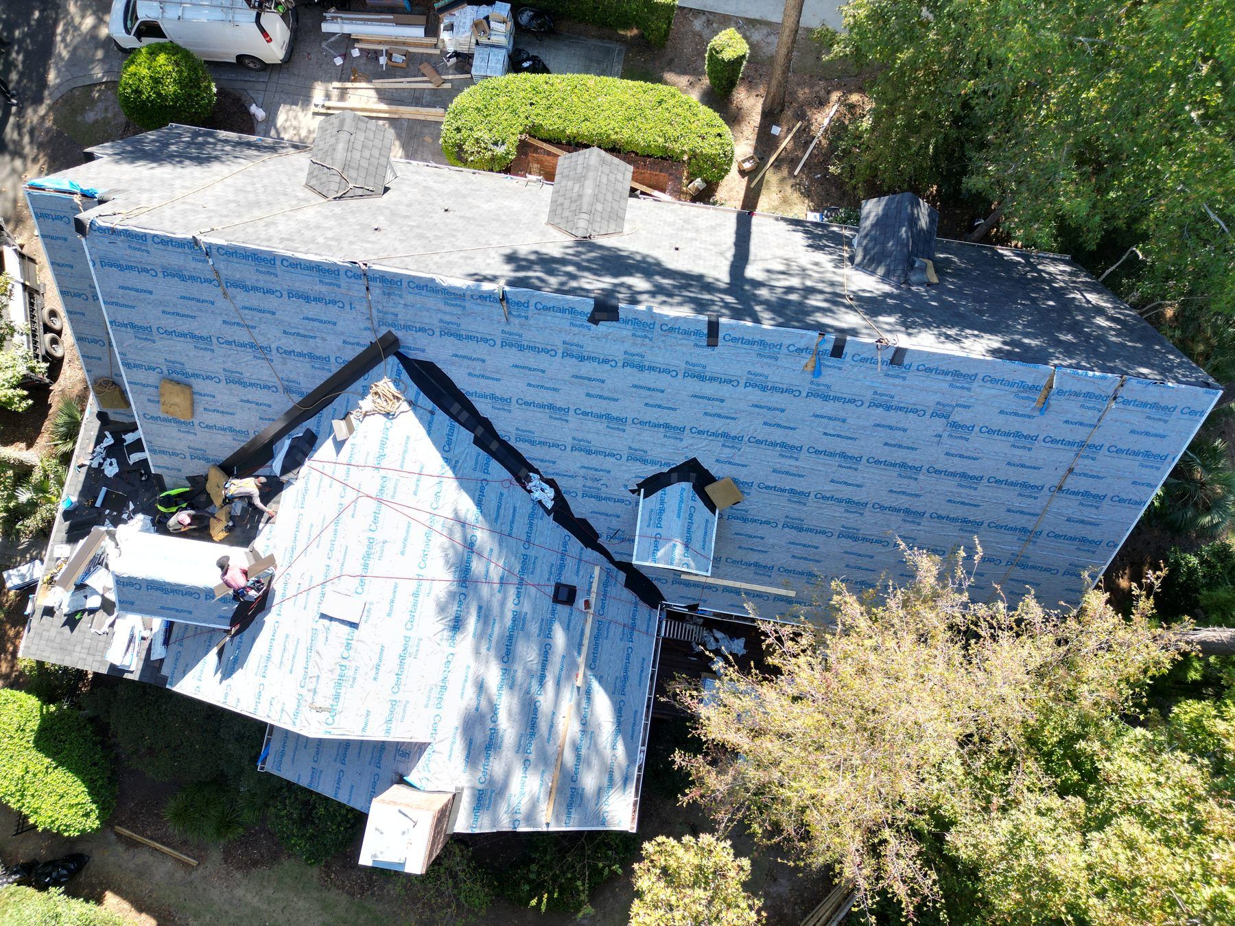 A whole roof covered in blue-gray underlayment before the shingles go on