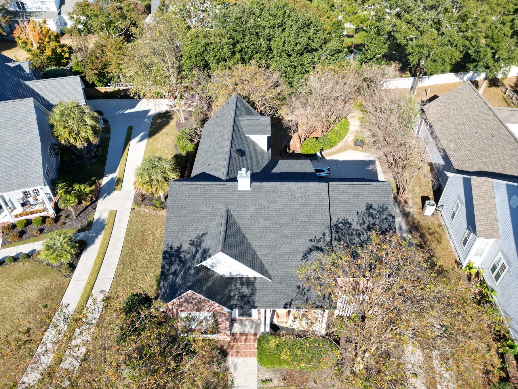 Brick home with a new charcoal architectural shingle roof, from above