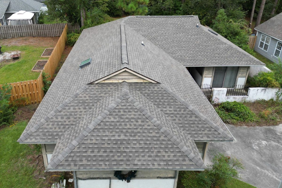 Single-story home with a weathered wood shingle roof, from above